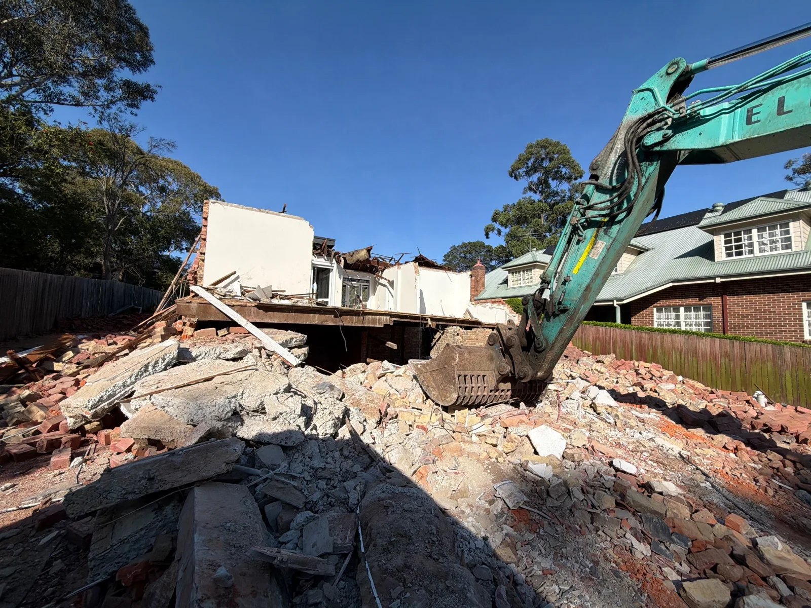 Excavator and partially demolished building at 9 Barons Crescent · 2026-10-01