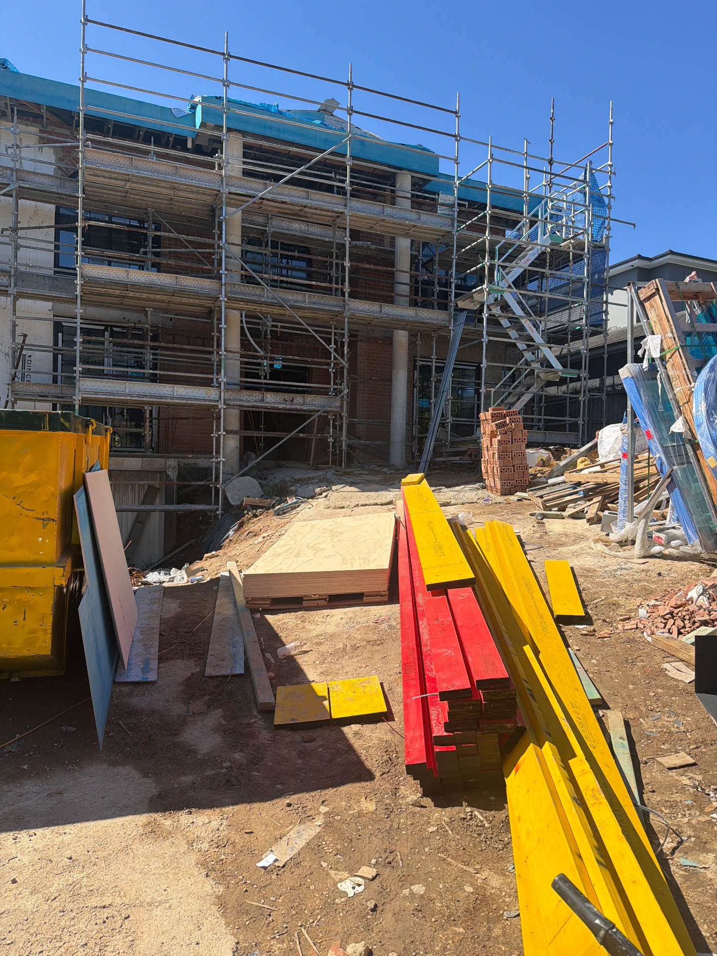 Building exterior, scaffolding and stored materials at 14 Wolsten Avenue.