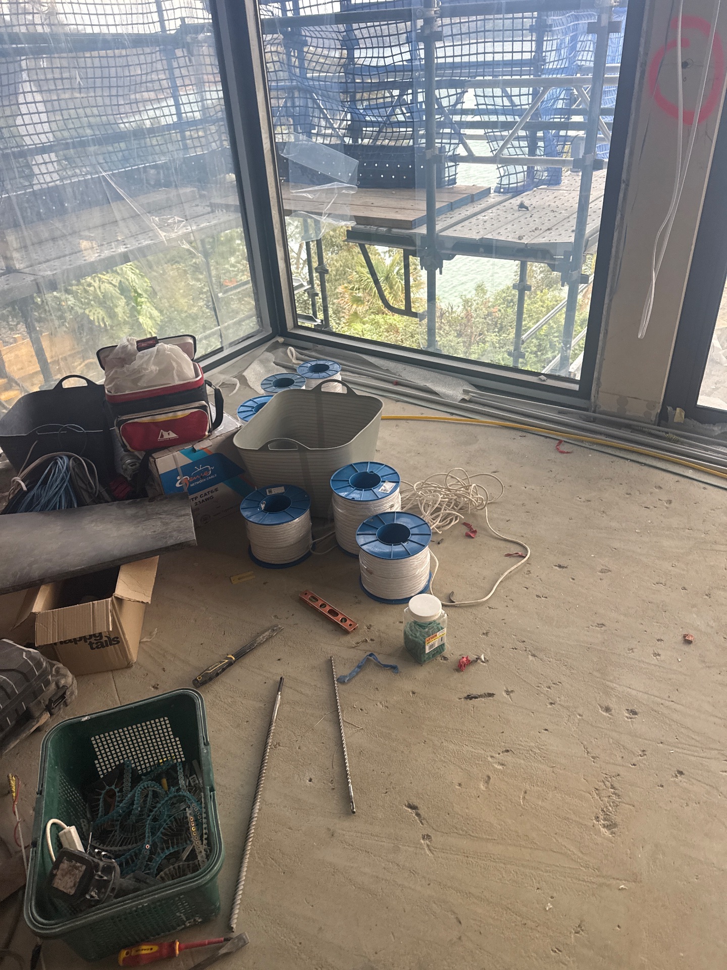Window installation and scaffold viewed from inside a residential build